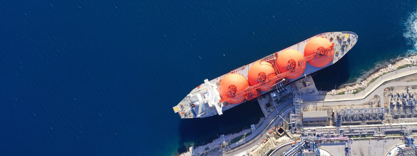 Liquefied natural gas carrier with spherical tanks at an export terminal